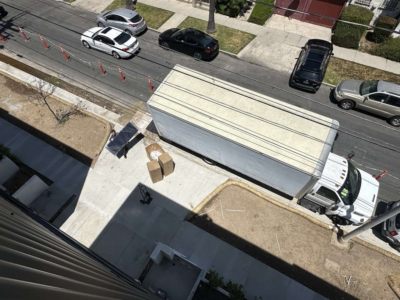 Mid City moving company unloading furniture for a staging job at a brand-new condo in Mid City, Los Angeles.
