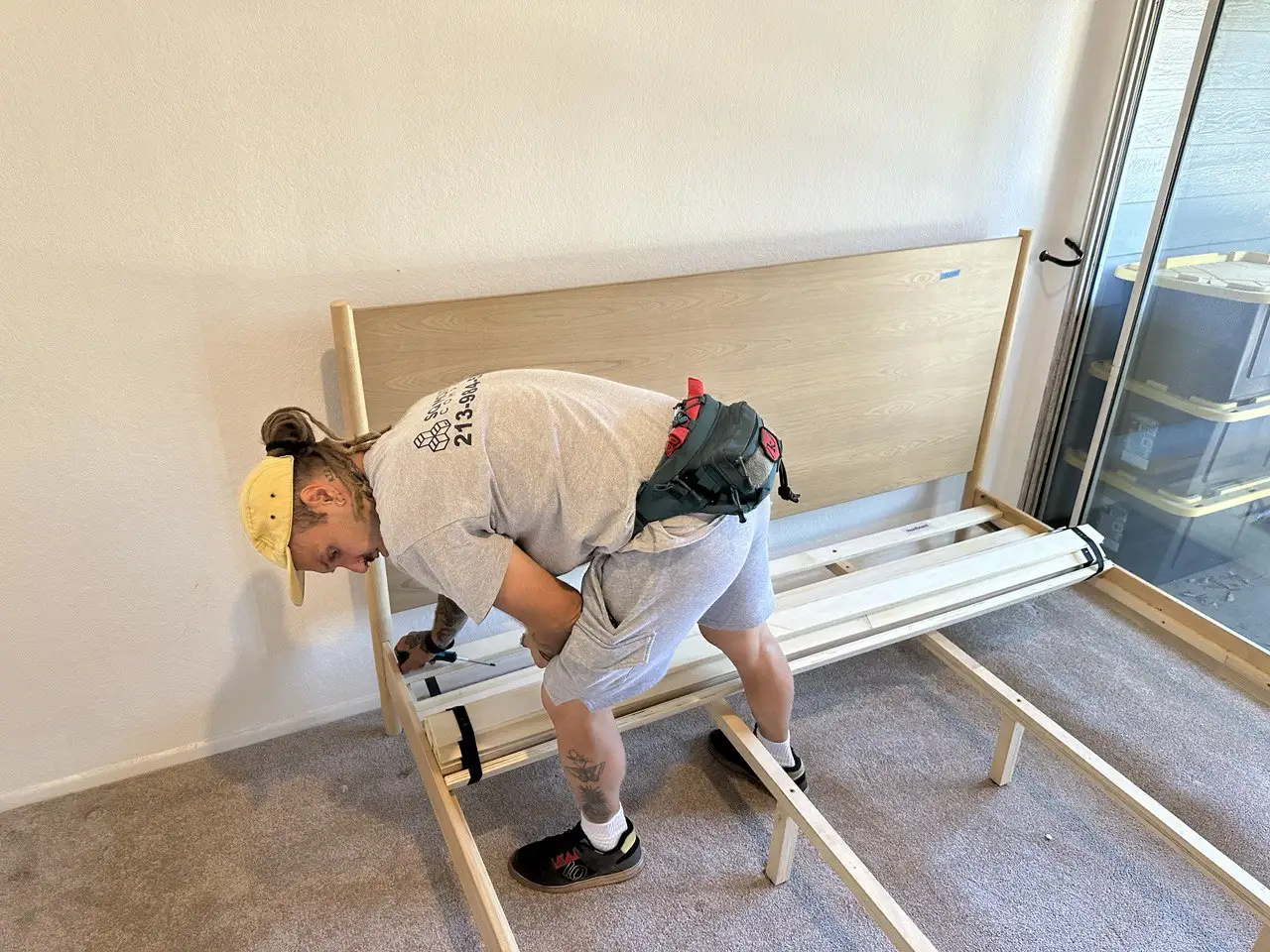 SQ Moving Company movers disassembling a bed professionally before packing and loading