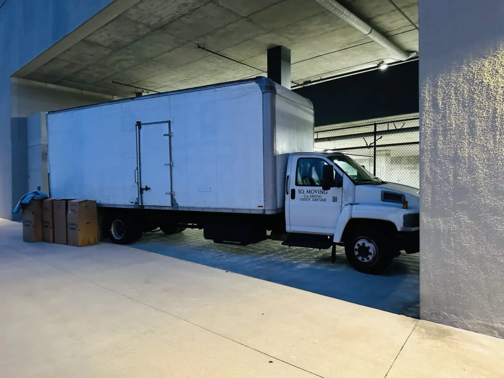 Moving truck parked in the loading zone of a high-rise building