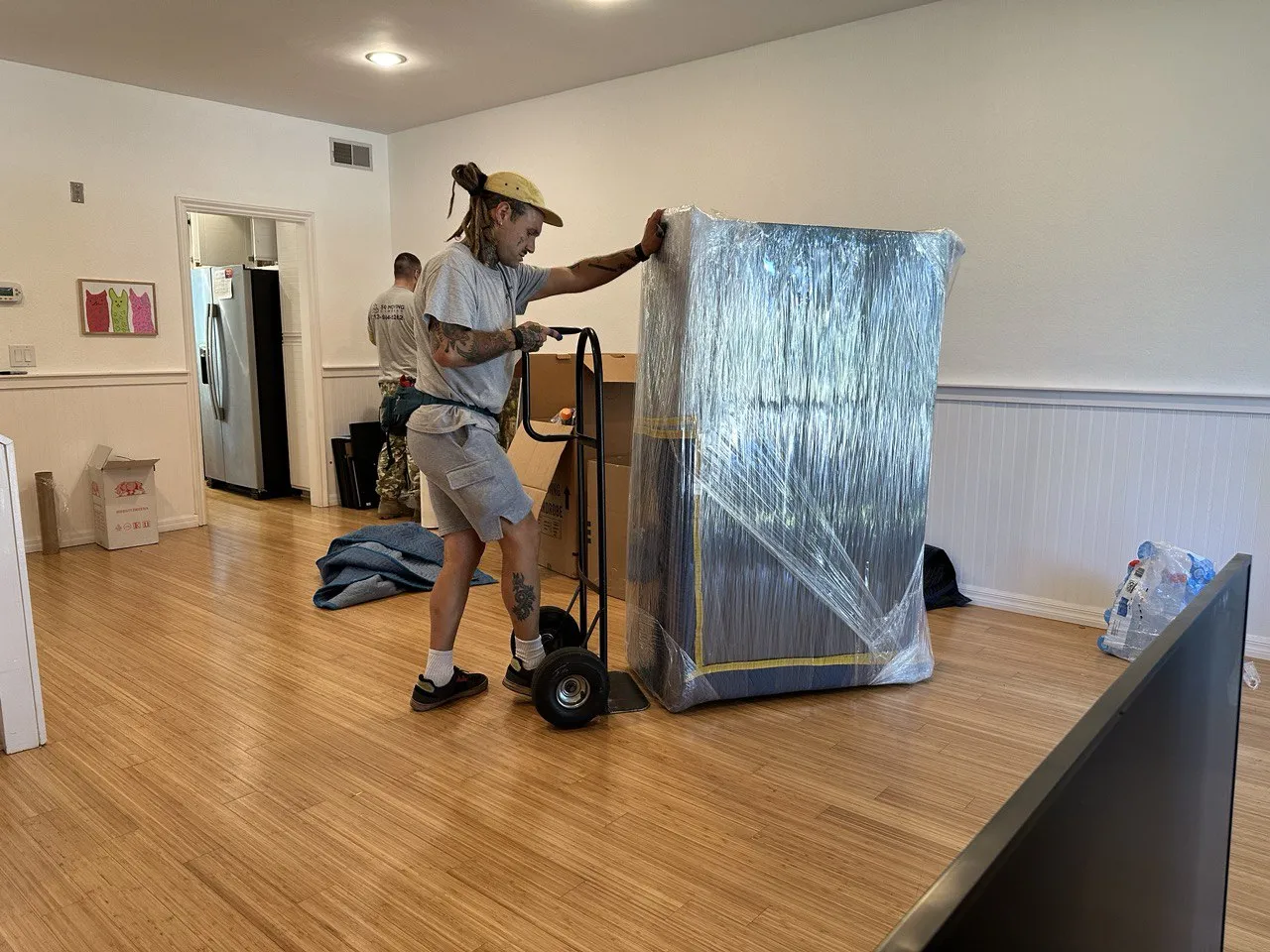Professional Encino movers handling wrapped furniture during a move