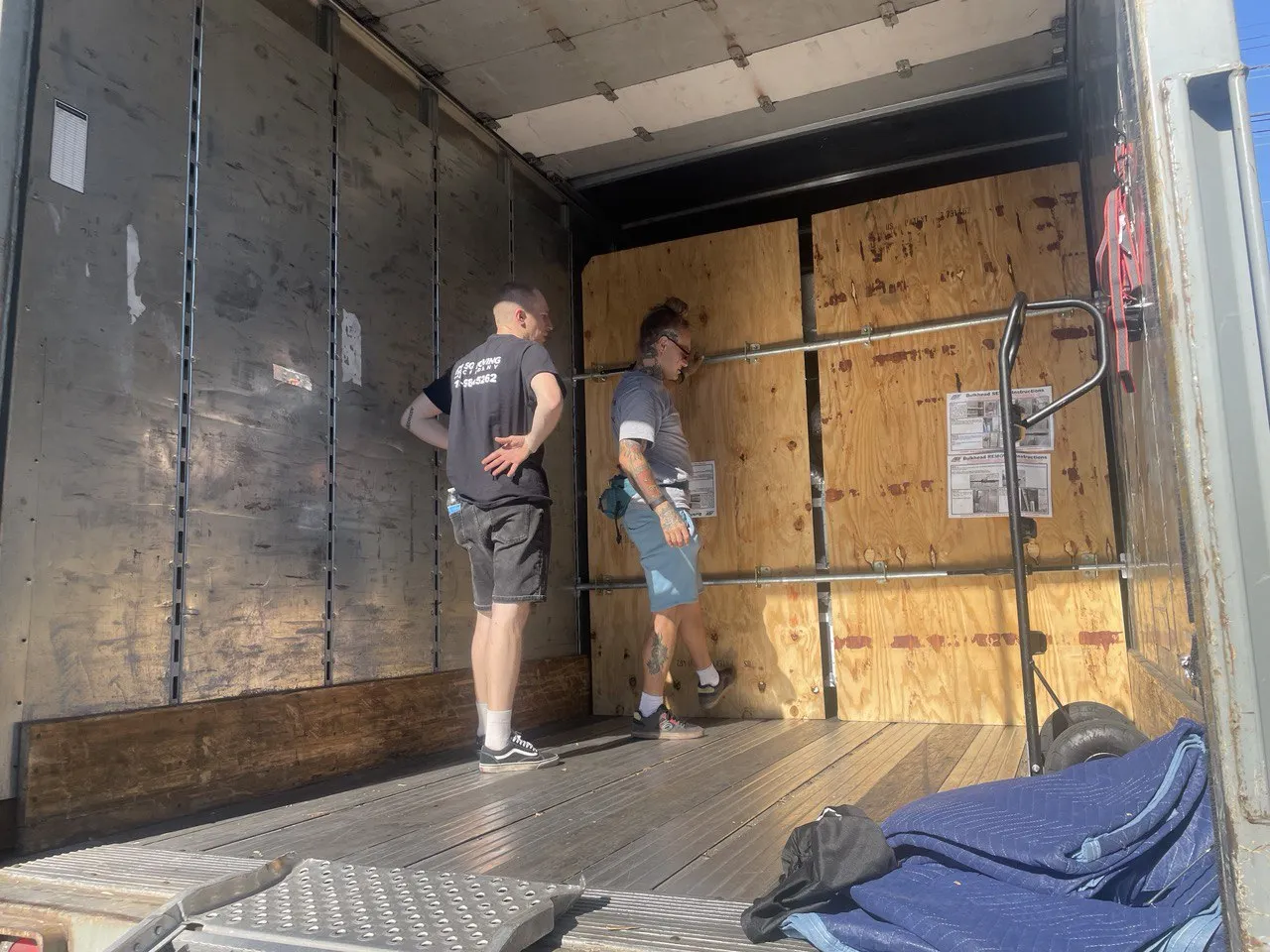 Professional labor movers unloading items from a moving truck