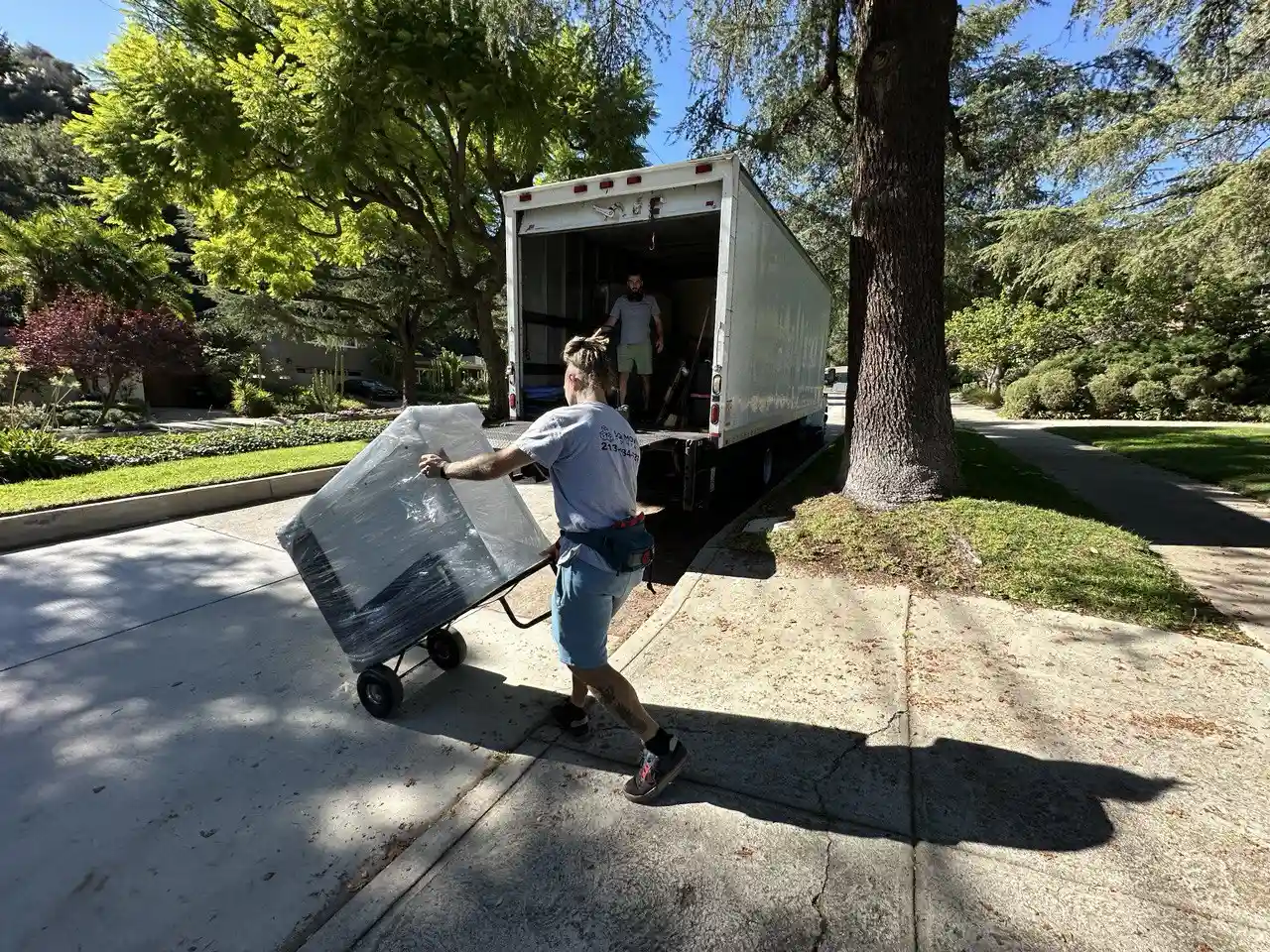 White glove movers in Miracle Mile professionally handling and protecting delicate furniture during a premium move