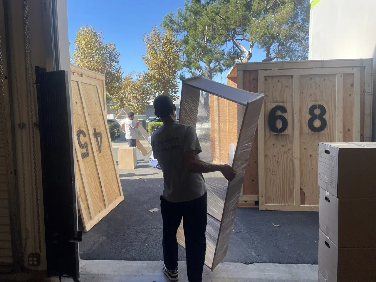 Professional movers providing labor-only services while loading a shipping container