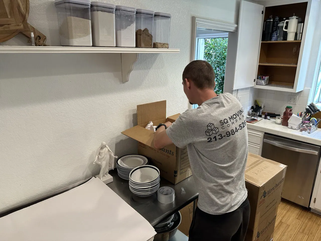 Venice Beach movers professionally packing kitchen dishes and fragile items during a residential move