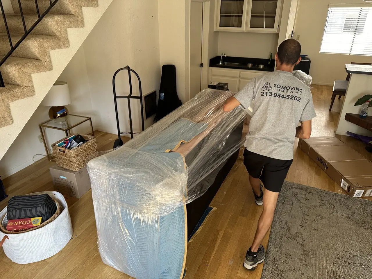 White glove movers in Sierra Madre carefully transporting artwork and fine furnishings into a luxury hillside home