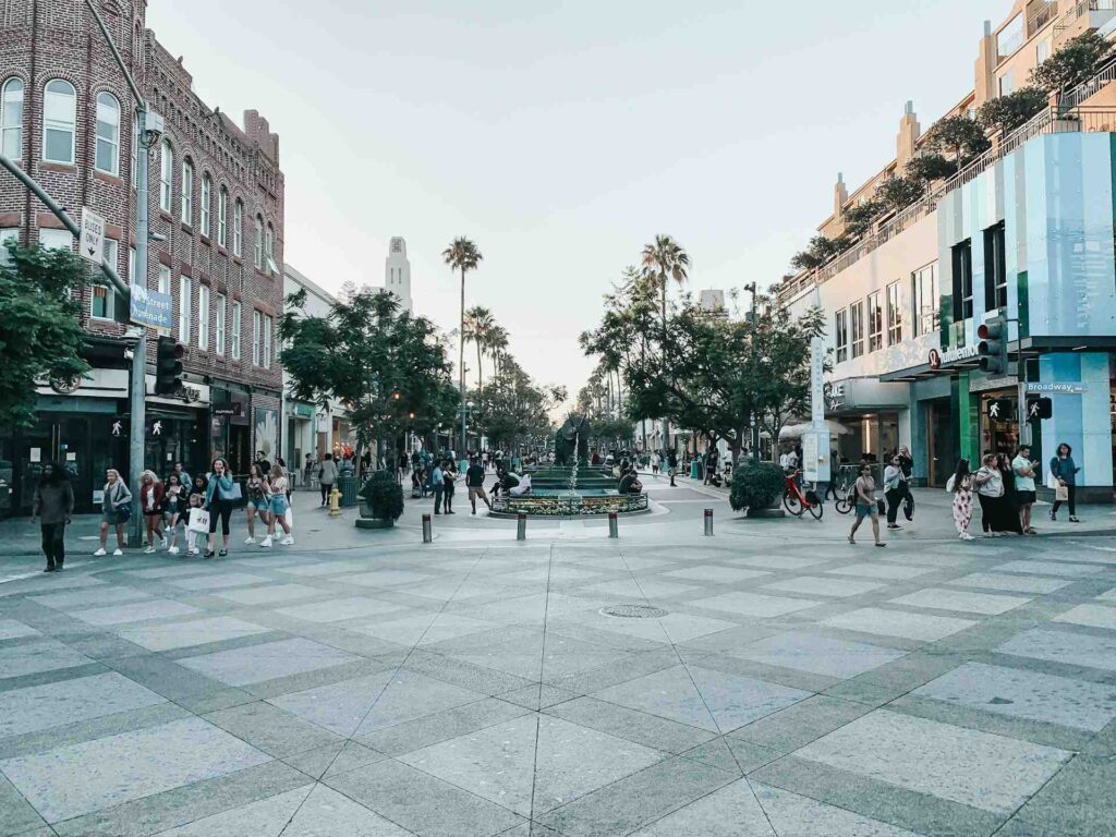 Moving to Santa Monica: Your Complete 2025 Guide to Living, Working & Thriving by the Coast 2 Downtown Santa Monica lifestyle scene at Third Street Promenade with people walking, shopping, and enjoying outdoor spaces.