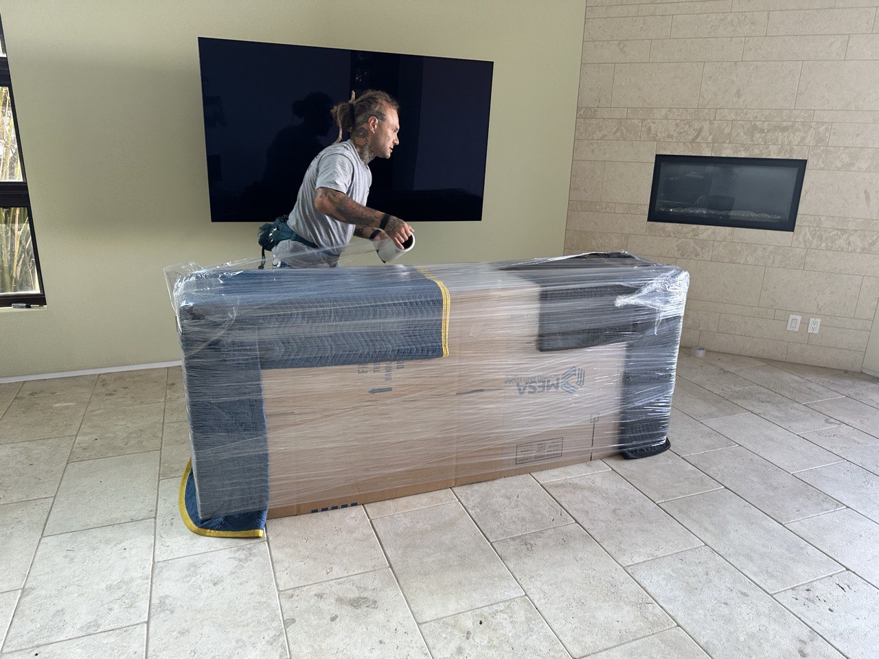 Mid City movers packing a large dresser and preparing it for safe loading.