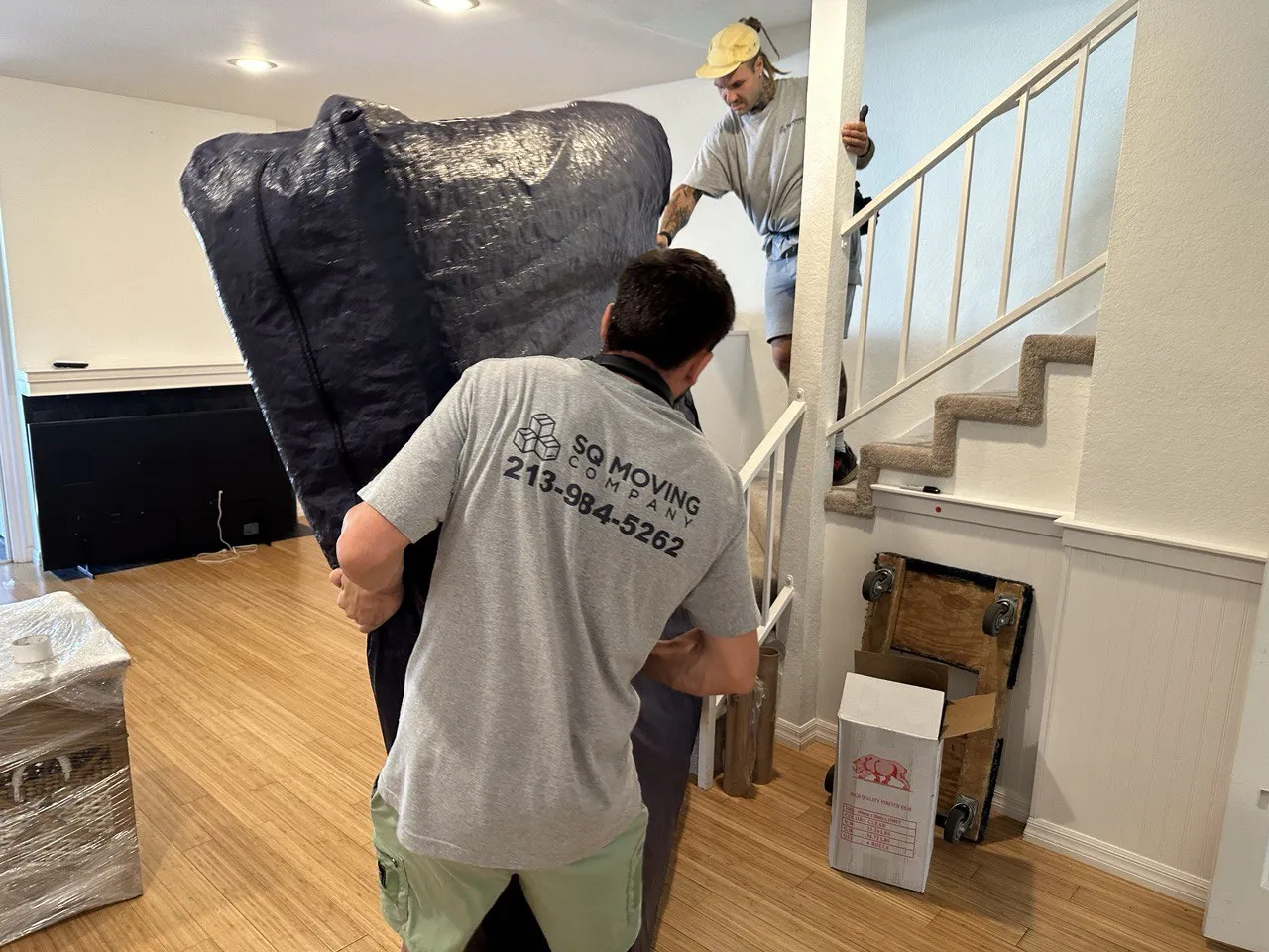 Professional moving company in Miracle Mile packing a mattress and carrying it to the moving truck