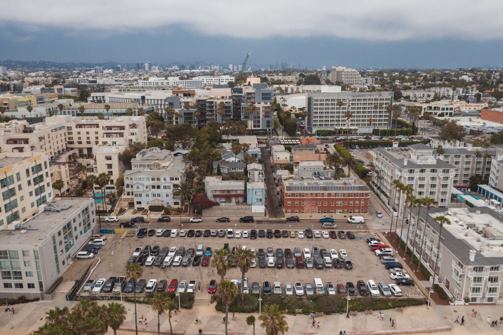 Moving to Santa Monica: Your Complete 2025 Guide to Living, Working & Thriving by the Coast 4 Modern apartments in Santa Monica near the beach with palm trees and sunny coastal views.