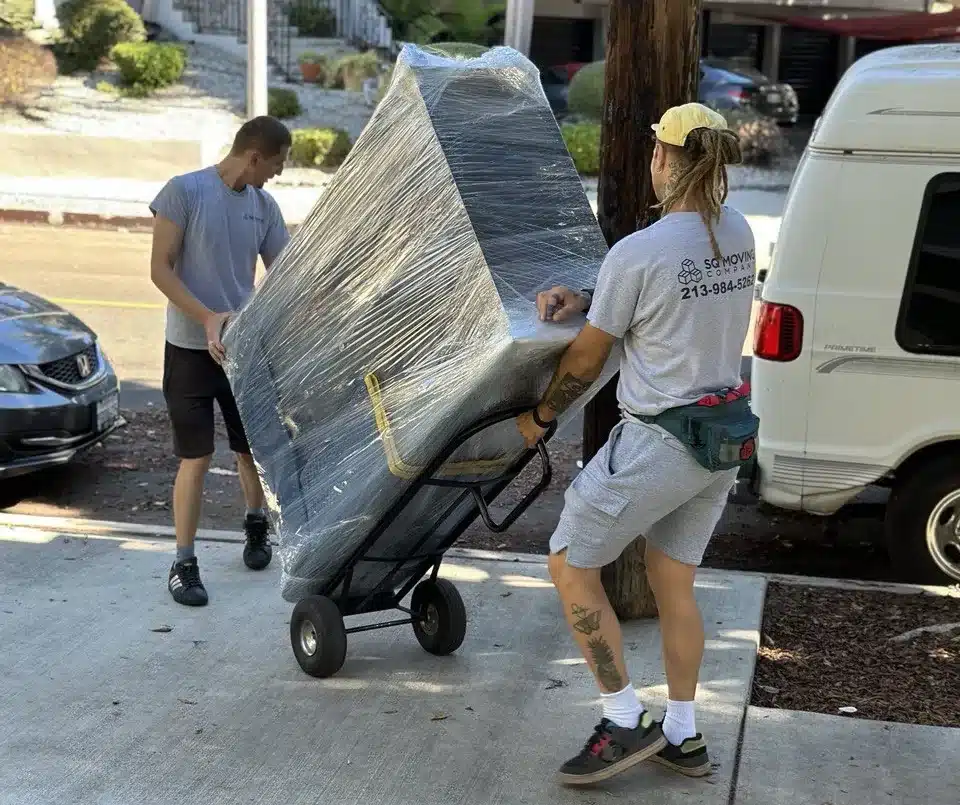 moving-packed-dresser-on-the-handtruck (1) Shrink-wrapped dresser secured on a hand truck | how to prepare furniture for moving