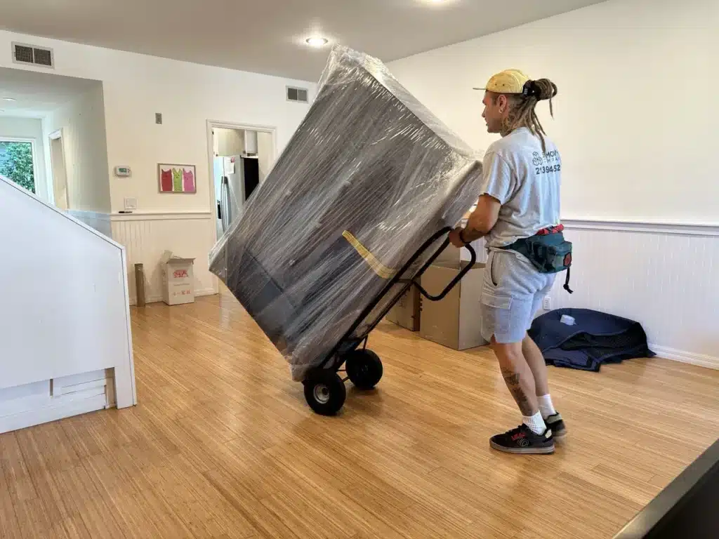 How to Prepare Furniture for Moving in LA: Step-by-Step Guide 8 packed dresser on the hand truck during the move in south bay area