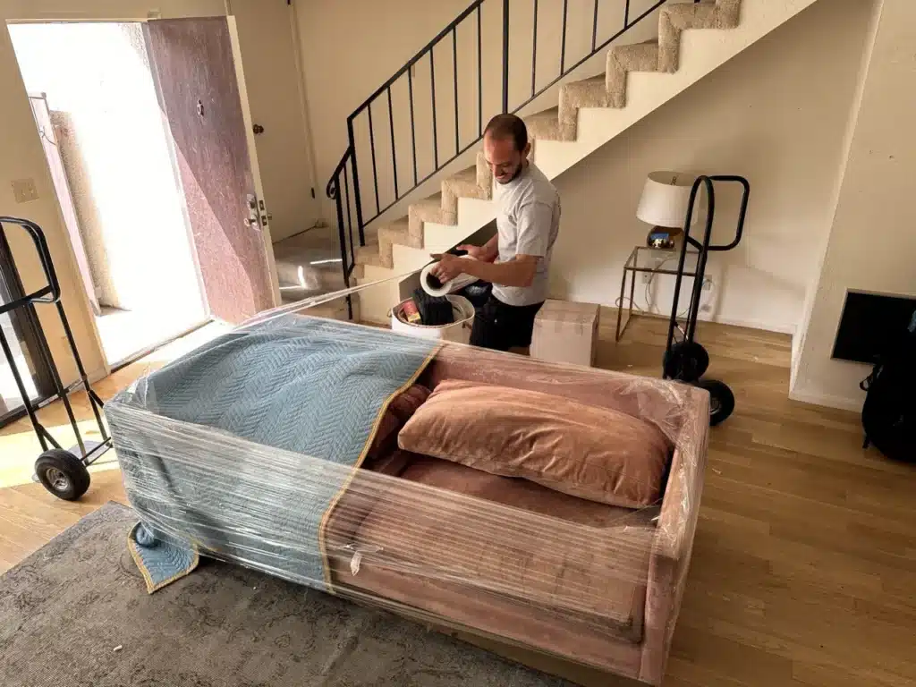 How to Prepare Furniture for Moving in LA: Step-by-Step Guide 4 How to pack a sofa. Packing of the sofa with blanket and shrink wrap.