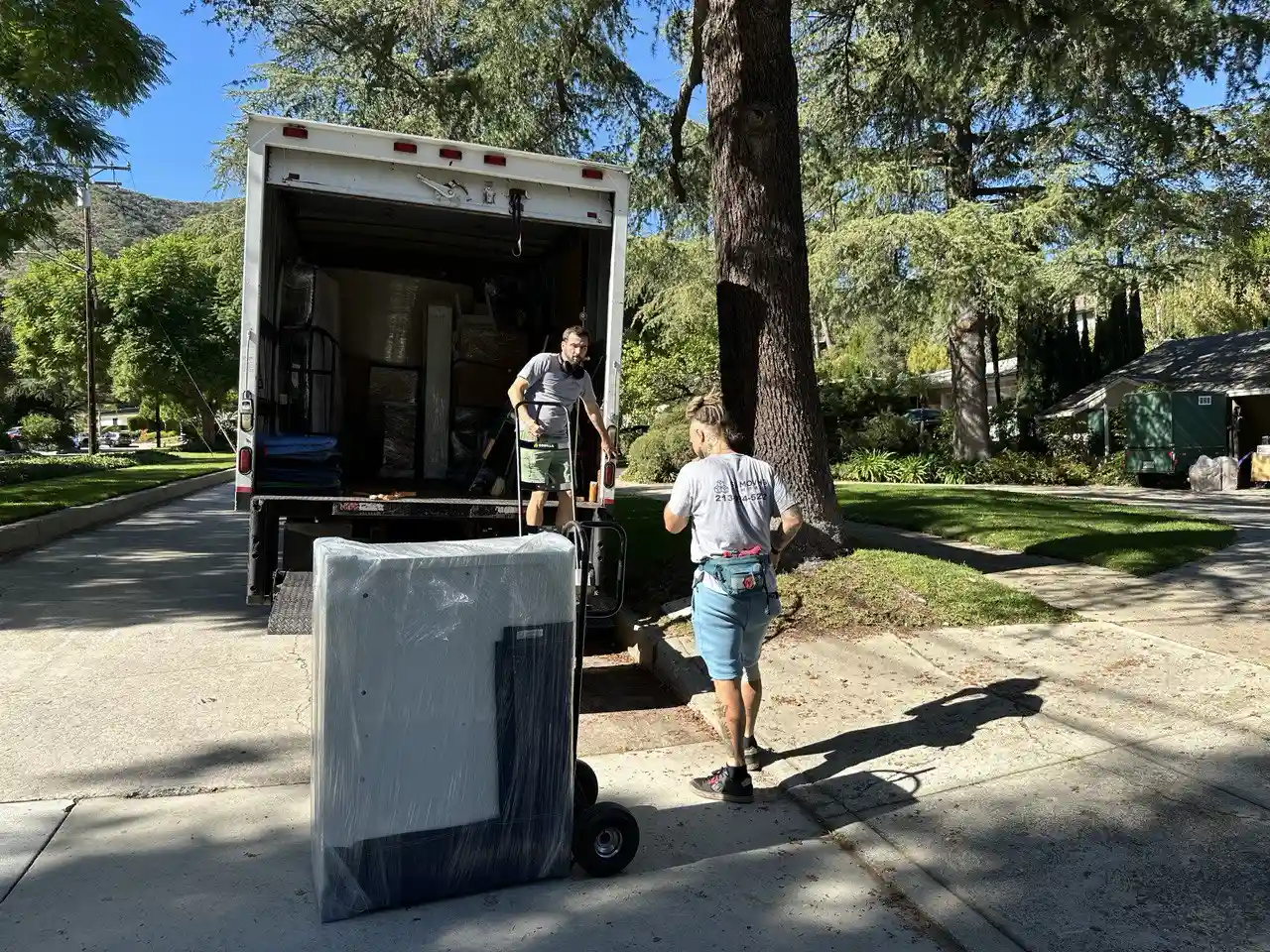 SQ Moving Company truck parked on a quiet residential street in Arcadia, CA
